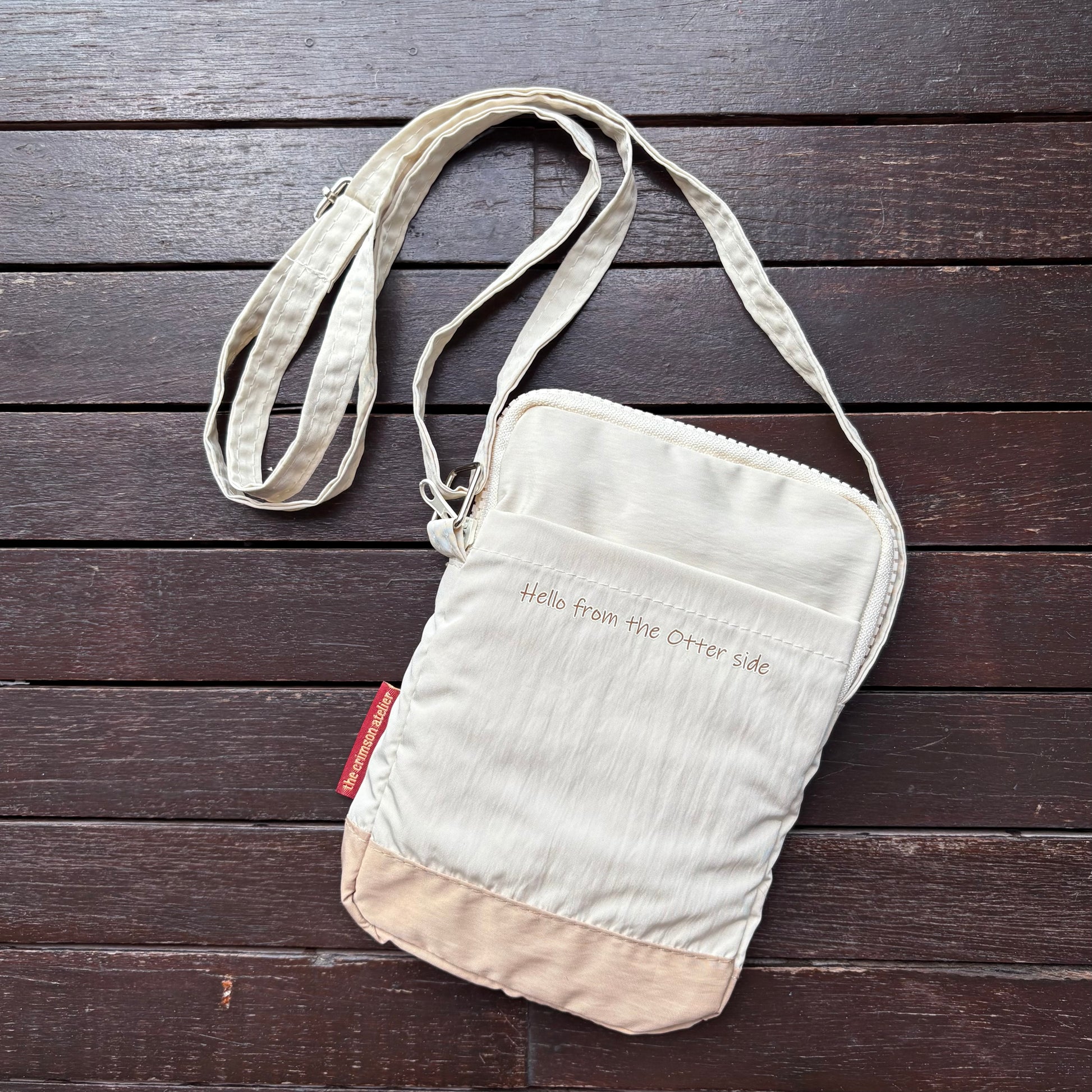 Otterwise Crossbody Bag Back with "Hello from the Otter Side" words and a back compartment