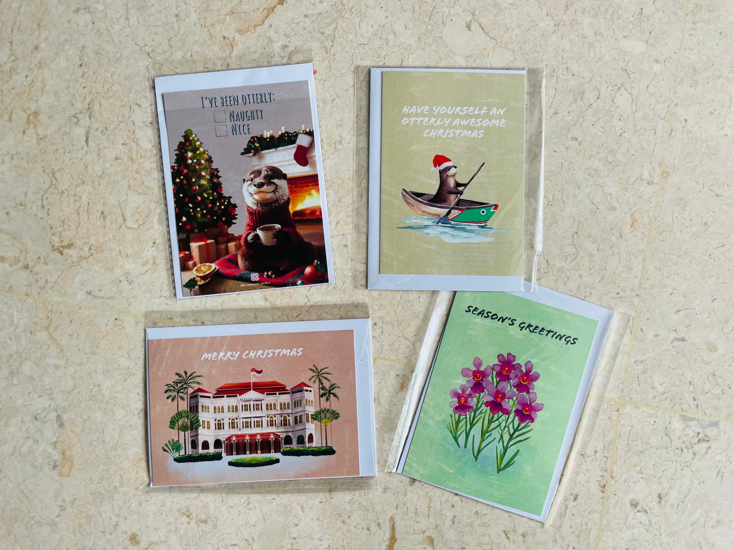 Assorted Christmas cards with envelopes, featuring different designs with festive messages.